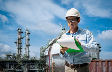 asian technician working with the checklist in industrial plant.