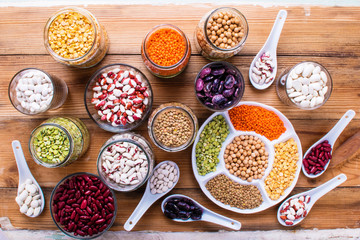 Wall Mural - Raw legume on old rustic wooden table, top view.