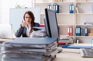 Beautiful female employee unhappy with excessive work 