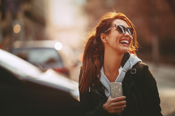 young happy woman on the street in the city