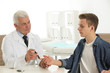 © New Africa - Doctor taking patient's blood sample with lancet pen in hospital. Diabetes control