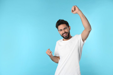 Portrait of happy young man on color background. Space for text