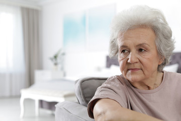 Wall Mural - Portrait of mature woman in living room