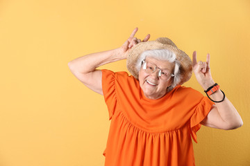 Wall Mural - Portrait of cool grandmother on color background, space for text