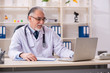 © Elnur - Aged male doctor working in the clinic