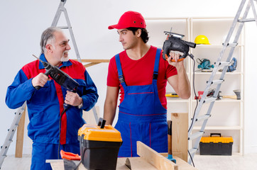 Two professional contractors laying flooring at home  