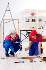 Two professional contractors laying flooring at home  