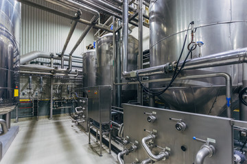 Industrial stainless steel vats in modern brewery 