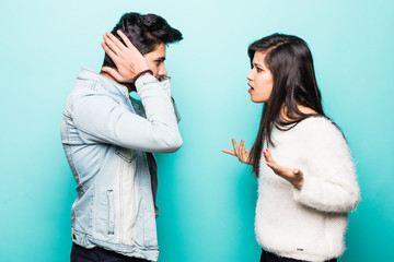 Closeup portrait of two indian people, couple woman and man quarrel with each other, isolated on green background. Marriage, relationship problems. Negative emotions