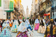 canvas print picture - Several of the thousands of women Falleras who parade down the street of La Paz with their typical Valencian Spanish dresses during the offering of Fallas to the Virgin, seen from behind.