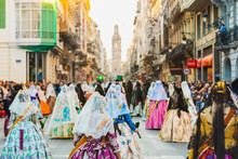 Several Of The Thousands Of Women Falleras Who Parade Down The Street Of La Paz With Their Typical Valencian Spanish Dresses During The Offering Of Fallas To The Virgin, Seen From Behind.