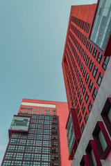 Low angle view of two corporate buildings  on blue sky