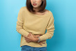 © suriya - asian young woman having painful stomachache