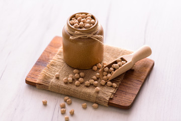 Portion of Chick Peas in ceramic bowl on table. Natural vegan food.