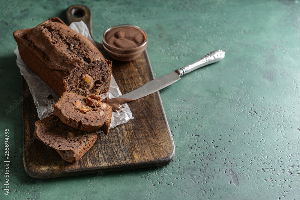 Tasty homemade cake with chocolate sauce on color table