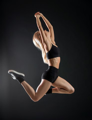 Poster - Young female dancer on dark background