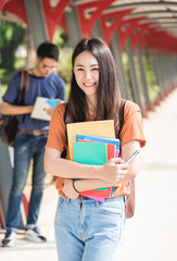 Wall Mural - Young woman girl, student hold note book at college