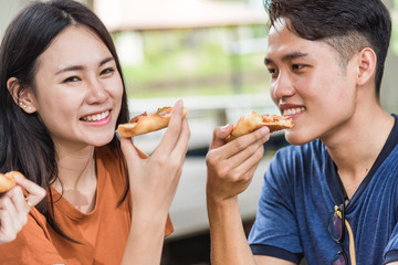 Wall Mural - Students group woman and man eating pizza together