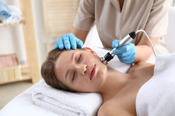 Poster - Young woman undergoing procedure of rf lifting in beauty salon