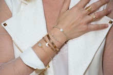 Close Up Detail Of Many Several Bracelet On A Female Hand Model