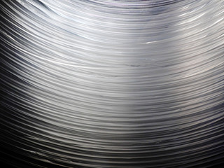 Many optical fiber cables hanging, forming an arc shape. This cables allow internet to work, provide connection between internet users.