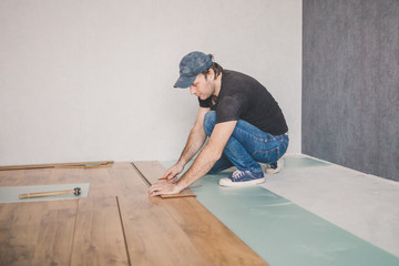 Wall Mural - Finishing work at home - laying a new laminate flooring