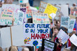 © ink drop - People with banners protest as part of a climate change march