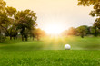 White Golf ball on green course to be shot on blurred beautiful landscape of golf course in bright day time with copy space. Sport, Recreation, Relax in holiday concept	