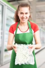 Wall Mural - Employee at hypermarket holding frozen beans.