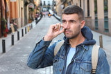 Fototapeta Miasto - Guy picking his nose outdoors 