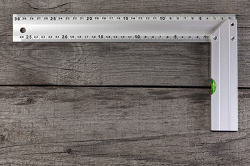 Measuring instrument on a wooden background. Tool for repair and construction.