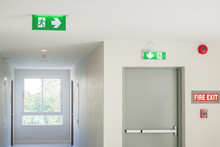 Fire Exit Sign With Light On The Path Way In The Hotel Or Office