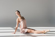 © LIGHTFIELD STUDIOS - young ballerina in pink dress sitting on floor in sunlight
