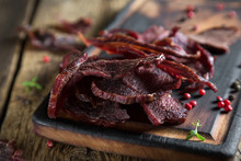 Beef Jerky On A Rustic Wooden Table