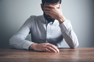 Wall Mural -  man hand on face on desk