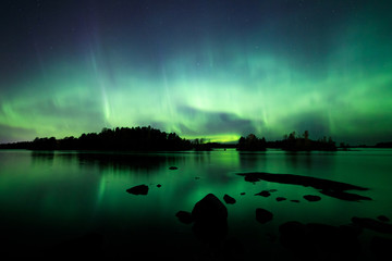 Wall Mural - Beautiful northern lights over lake