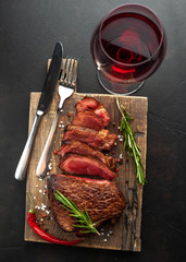 Wall Mural - Grilled beef steak with red wine, herbs and spices. View from above