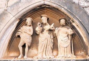 Jesus Christ, St. John the Baptist and St. Nicholas with a stick, portal of Saint Luke Church in Dubrovnik, Croatia 