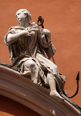 Wall Mural - Symbols of Faith, statue on the portal of St. Barbabas Church, Italy 