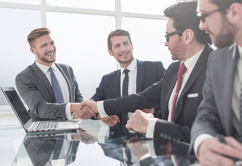 Wall Mural - handshake financial partners over the negotiating table.