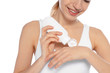 © New Africa - Young woman applying hand cream on white background, closeup. Beauty and body care