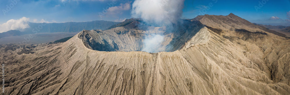Beautiful panorama view of Mount Bromo volcano in East Java of Indonesia. An iconic most popular tourist attraction in Java island. - obrazy, fototapety, plakaty 
