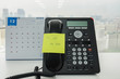 © jummie - sticky note with call me back message on IP landline phone with December calendar backdrop