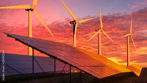 Photographie clean energy concept, photovoltaic panels and wind turbines in the light of the