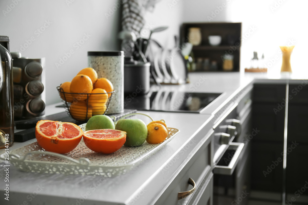 Tray with fresh fruits on counter in kitchen