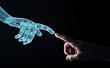 © sdecoret - Wireframed Robot hand making contact with human hand on dark 3D rendering