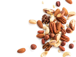 Wall Mural - Background of nuts - pecan, macadamia, brazil nut, walnut, almonds, hazelnuts, pistachios, cashews, peanuts, pine nuts.Copy space. Isolated one edge on white with clipping path. Top view or flat lay