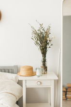 Soft Home Decor, Small Vases With Wildflowers, Straw Hat, Candle In  Bedroom. White, Pastel Background 