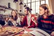 © zinkevych - Company of three young musicians eating yummy pizza for lunch