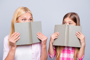 Poster - Close up photo funny funky blond hair hide cover face she her grandma little granddaughter hold read books impressions feelings wear casual pink plaid checkered shirt sweater isolated grey background